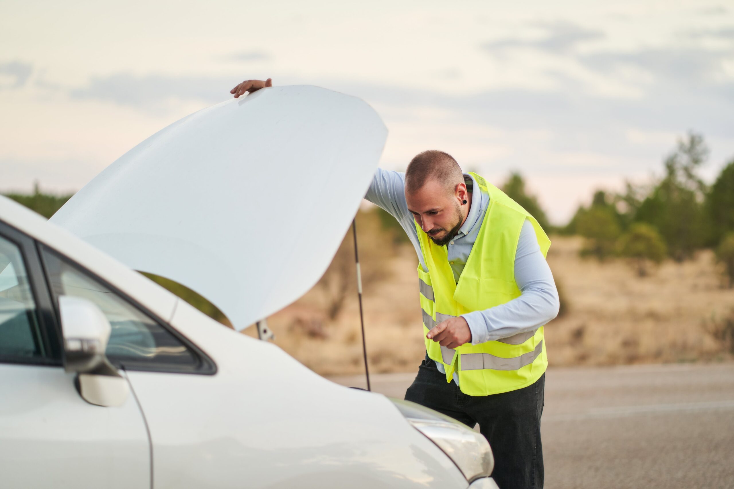 a-man-looking-at-the-engine-of-his-car-wearing-an-2024-12-04-13-48-04-utc-min
